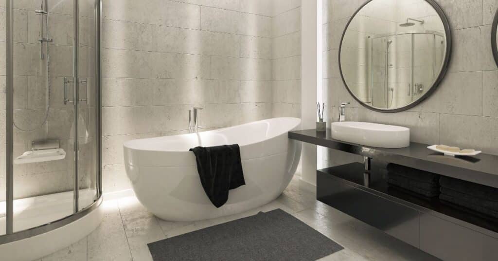 Modern bathroom with oval freestanding tub, glass shower, and floating vanity.