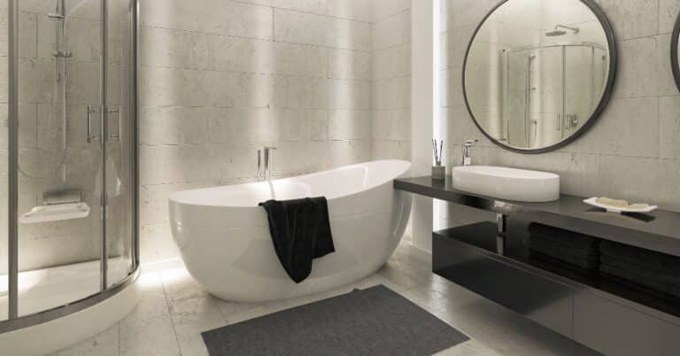 Modern bathroom with oval freestanding tub, glass shower, and floating vanity.